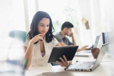 Young woman and man working in office.