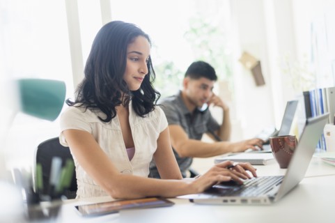 Young woman and man working in office.