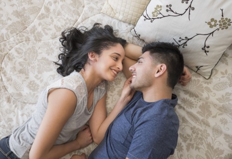 Young couple lying on bed.