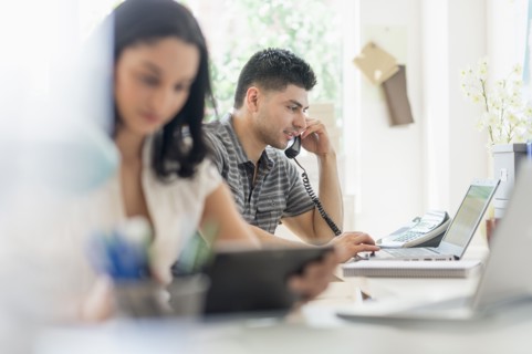 Young man and woman working in office.