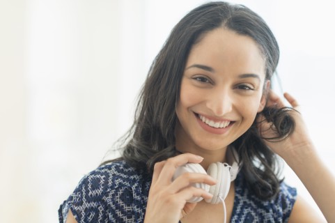 Portrait of smiling young woman with headphones.
