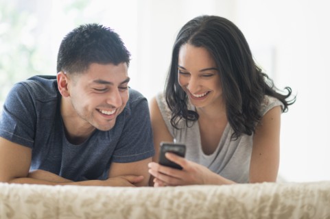 Young couple relaxing on bed.