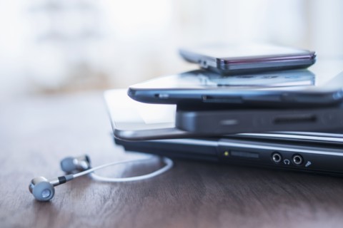 Close up of stack of devices on desk.