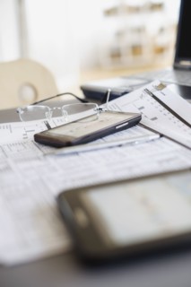 Close up of glasses on paperwork.