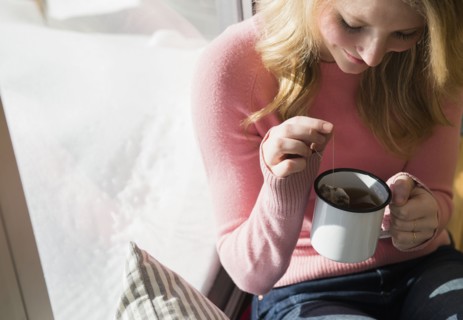 Woman steeping tea in mug.
Photo : Jamie Grill