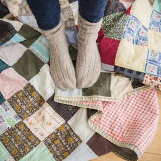 Elevated view of woman's legs wearing woolen socks.
Photo : Jamie Grill