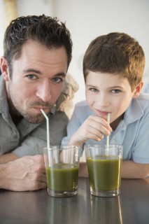 Father and son (8-9) drinking juice.
Photo : Jamie Grill