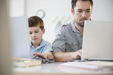 Father and son (8-9) working on laptops.
Photo : Jamie Grill