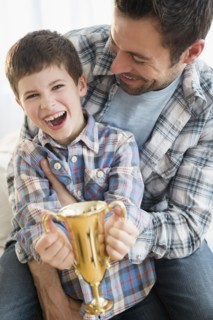 Father and son (8-9) holding trophy.
Photo : Jamie Grill