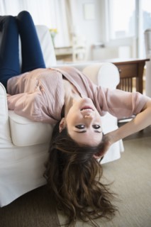 Young woman relaxing on sofa .
Photo : Jamie Grill
