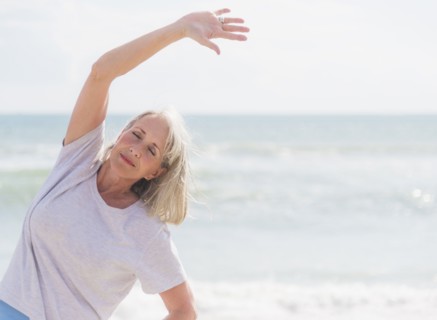 Senior woman exercising on beach.
Photo : Daniel Grill