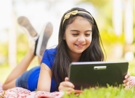 girl ( 8-9) using digital tablet .
Photo : Daniel Grill