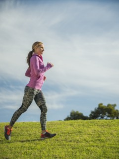 Woman running through lawn.