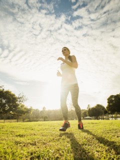 Woman running through lawn.