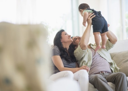 Family with baby son (6-11 months) in living room.