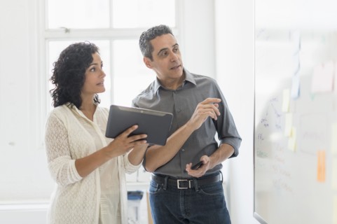 Man and woman working together in office.