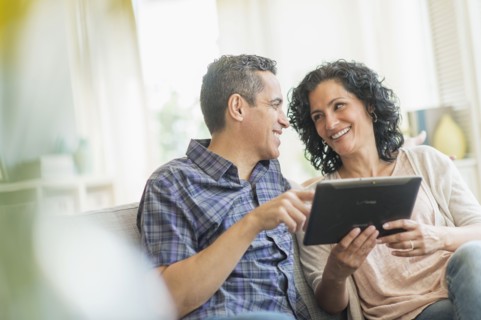 Couple using digital tablet.