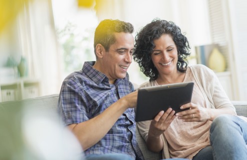 Couple using digital tablet together.