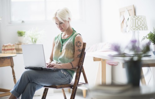 Woman using laptop at home.