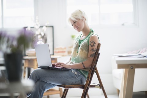 Woman using laptop at home.