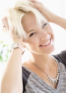 Portrait of blonde woman wearing necklace.