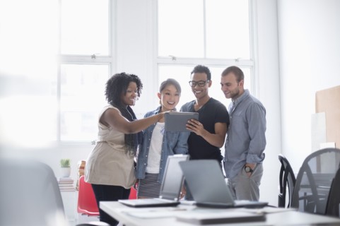 Women and men working in office.