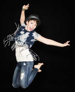 Portrait of young woman jumping.