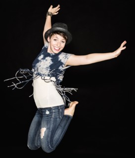 Portrait of young woman jumping.