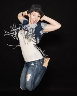 Portrait of young woman jumping.