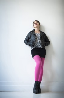 Woman wearing leather jacket, mini skirt and ping tights.