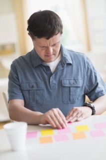 Man with down syndrome playing memory game.