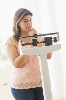 Woman standing on scale.