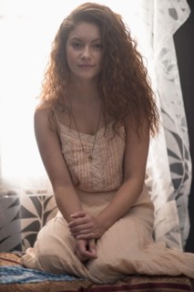 Portrait of stylish woman in window sill.
