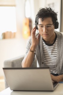 Man mixing music on laptop.