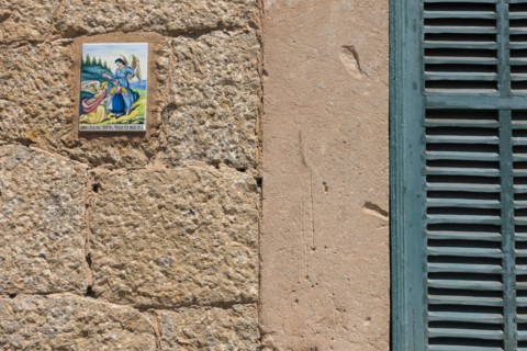 Close up of tile with angels on wall. Valldemossa, Mallorca, Spain.