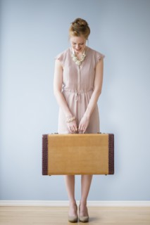 Young woman holding suitcase