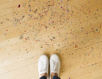 Woman's feet and confetti on floor