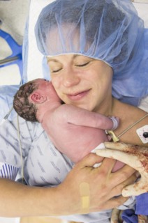 Mother holding newborn daughter