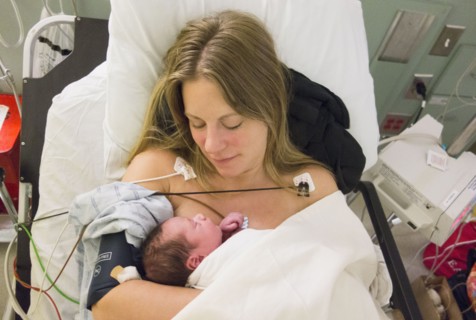 Mother holding newborn daughter