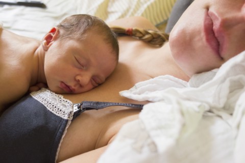 Mother holding newborn daughter