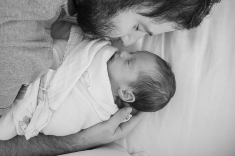 Father holding newborn daughter