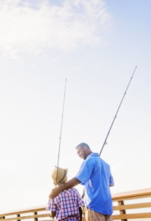 Father and son (10-11) fishing