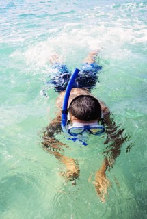 Boy (10-11) snorkeling in sea