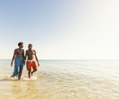 Mature couple walking in sea