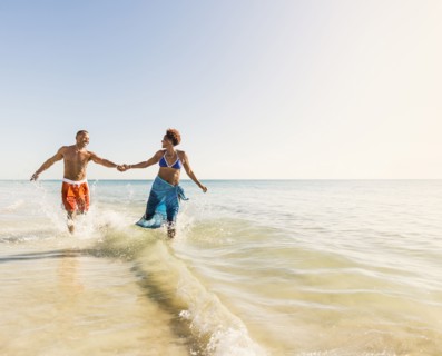 Mature couple running in sea