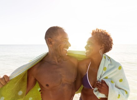 Mature couple embracing on beach