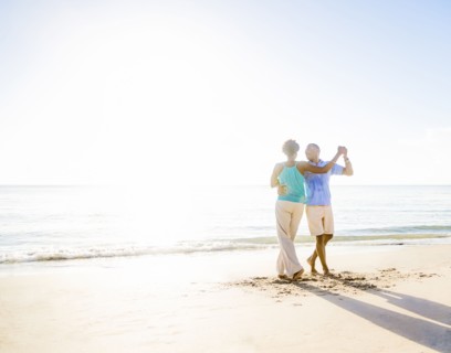 Mature couple dancing on beach