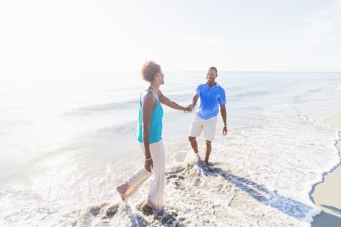 Mature couple walking on beach