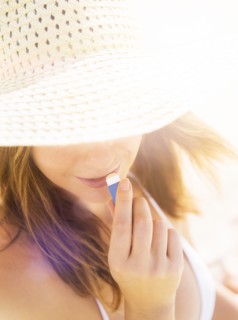 Woman applying lip balm