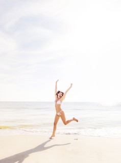 Woman jumping on beach